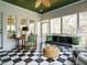 Cozy sunroom with checkered floors and large windows showcasing outdoor views at 3321 Marblehead Ln, Raleigh, NC 27612