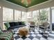 Inviting sunroom with bright natural light and a black and white checkered floor at 3321 Marblehead Ln, Raleigh, NC 27612