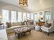 Bright sunroom with large windows, plush seating, and natural light, creating a peaceful relaxation space at 3321 Marblehead Ln, Raleigh, NC 27612