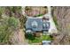 Birds eye view of a home featuring mature landscaping, a winding drive, separate garage and a secluded wooded area at 3424 Forest Oaks Dr, Chapel Hill, NC 27514