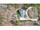 Aerial view of a charming house with mature landscaping, circular driveway, separate garage, and secluded wooded setting at 3424 Forest Oaks Dr, Chapel Hill, NC 27514