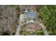 Aerial view of home with circular driveway and mature landscaping, complemented by a detached garage and wooded surroundings at 3424 Forest Oaks Dr, Chapel Hill, NC 27514