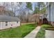 Backyard featuring a well-maintained shed, lush greenery, mature trees and a convenient walkway at 3424 Forest Oaks Dr, Chapel Hill, NC 27514