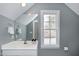 Bright bathroom featuring a large vanity, a window that provides natural light and grey painted walls at 3424 Forest Oaks Dr, Chapel Hill, NC 27514
