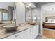 Bathroom boasts stone counter tops, dual vessel sinks, and is adjacent to the bedroom at 3424 Forest Oaks Dr, Chapel Hill, NC 27514