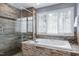 Luxurious bathroom with a soaking tub, glass enclosed shower and a large window at 3424 Forest Oaks Dr, Chapel Hill, NC 27514