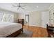 Large bedroom with hardwood floors, neutral colors and a large window at 3424 Forest Oaks Dr, Chapel Hill, NC 27514