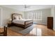 Spacious bedroom features hardwood floors, large windows and a ceiling fan at 3424 Forest Oaks Dr, Chapel Hill, NC 27514
