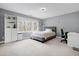 Bedroom with gray walls featuring a window seat, neutral carpet and a modern bed at 3424 Forest Oaks Dr, Chapel Hill, NC 27514