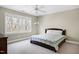 Bedroom with neutral carpet features a large window and a comfy bed at 3424 Forest Oaks Dr, Chapel Hill, NC 27514