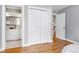 Bedroom with open doorway to the bathroom, a closet and a staircase view with hardwood floors at 3424 Forest Oaks Dr, Chapel Hill, NC 27514