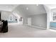 Large bonus room with neutral carpet, built-in shelving and window seats plus a ceiling fan at 3424 Forest Oaks Dr, Chapel Hill, NC 27514