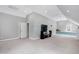 Bonus room with neutral carpet featuring a TV, a ceiling fan and access to a full bath at 3424 Forest Oaks Dr, Chapel Hill, NC 27514