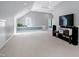 Bonus room with neutral carpet and blue accent featuring a TV and built-in seating at 3424 Forest Oaks Dr, Chapel Hill, NC 27514