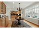 Bright breakfast nook features a wooden table, modern chairs, and a large window with natural light at 3424 Forest Oaks Dr, Chapel Hill, NC 27514