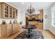 Cozy breakfast nook with wooden cabinets, round table, and glass shelving, adjacent to the kitchen at 3424 Forest Oaks Dr, Chapel Hill, NC 27514