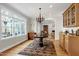 Sunlit breakfast nook boasts a rustic chandelier and access to a living area and an outdoor deck at 3424 Forest Oaks Dr, Chapel Hill, NC 27514