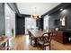 Dining room featuring dark accents, hardwood floors, and a large window at 3424 Forest Oaks Dr, Chapel Hill, NC 27514