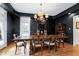 Formal dining room with dark walls, hardwood floors, and elegant lighting at 3424 Forest Oaks Dr, Chapel Hill, NC 27514