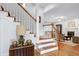 View of foyer showcasing staircase with wooden handrail, chandelier, and access to the living room and dining room at 3424 Forest Oaks Dr, Chapel Hill, NC 27514
