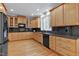 Spacious kitchen featuring maple cabinetry, dark countertops, stainless steel appliances, and hardwood floors at 3424 Forest Oaks Dr, Chapel Hill, NC 27514
