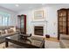 Living room featuring fireplace with marble surround, hardwood floors, and a neutral color palette and plenty of natural light at 3424 Forest Oaks Dr, Chapel Hill, NC 27514