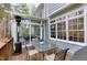 Outdoor patio area featuring a table, chairs and a gas heater outside of the sunroom at 3424 Forest Oaks Dr, Chapel Hill, NC 27514