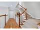 Elegant staircase with carpeted steps, a hardwood banister, and a bright hallway at 3424 Forest Oaks Dr, Chapel Hill, NC 27514