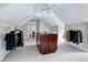 Well-organized walk-in closet with an island and multiple hanging rods for clothing at 3424 Forest Oaks Dr, Chapel Hill, NC 27514