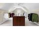 Spacious walk-in closet with an island, ample hanging space, and a ceiling fan at 3424 Forest Oaks Dr, Chapel Hill, NC 27514