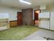 Open basement area with exposed brickwork and built in cabinetry, offering ample storage and living space at 3601 Colonial Ln, Rocky Mount, NC 27804