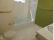 Bathroom features a toilet, bathtub, a sink, and neutral colored floors and tile at 3601 Colonial Ln, Rocky Mount, NC 27804