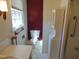 Bathroom featuring a red accent wall, and tile flooring at 3601 Colonial Ln, Rocky Mount, NC 27804