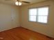 Bright bedroom featuring gleaming hardwood floors and a double window at 3601 Colonial Ln, Rocky Mount, NC 27804