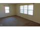 Bright bedroom featuring two large windows and neutral-toned walls and carpet at 3601 Colonial Ln, Rocky Mount, NC 27804