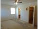 A bedroom with carpet flooring, a ceiling fan, and access to a bathroom and closet at 3601 Colonial Ln, Rocky Mount, NC 27804