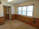 Bonus room featuring carpet flooring, wood trim walls, and a window offering natural light at 3601 Colonial Ln, Rocky Mount, NC 27804