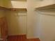 A walk-in closet with shelves, hardwood floors, and white painted walls at 3601 Colonial Ln, Rocky Mount, NC 27804