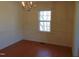 Dining room displaying laminate wood floors, chandelier, and single window at 3601 Colonial Ln, Rocky Mount, NC 27804