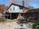 Back exterior view of the home features a brick facade, covered patio and chimney at 3601 Colonial Ln, Rocky Mount, NC 27804
