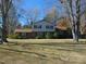 Traditional two-story home with well-maintained lawn and mature trees, providing a serene setting at 3601 Colonial Ln, Rocky Mount, NC 27804