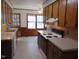 Eat-in kitchen featuring wood cabinets, vinyl floors, and white appliances at 3601 Colonial Ln, Rocky Mount, NC 27804