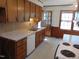 Traditional kitchen with wooden cabinetry, tile backsplash, and classic appliances at 3601 Colonial Ln, Rocky Mount, NC 27804