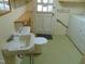 A laundry room featuring a sink, toilet, washing machine, and a door to the outside at 3601 Colonial Ln, Rocky Mount, NC 27804