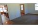 Living room showing a view into the kitchen with wood cabinets and white countertops at 3601 Colonial Ln, Rocky Mount, NC 27804