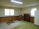 Spacious living room with two windows, wood panelling, carpeted floors, and a view of backyard at 3601 Colonial Ln, Rocky Mount, NC 27804