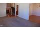 Carpeted living room highlighting an open staircase to the second floor and entry to dining room at 3601 Colonial Ln, Rocky Mount, NC 27804