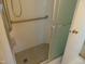 Bathroom shower with glass enclosure, tile surround, seat, and grab bar at 3601 Colonial Ln, Rocky Mount, NC 27804