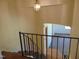 Stairway of a home featuring a unique wrought iron handrail, and hanging light fixture at 3601 Colonial Ln, Rocky Mount, NC 27804