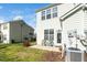 Exterior backyard view with a patio area, lawn, and an air conditioning unit at 3615 Ramblewood Ave, Durham, NC 27713